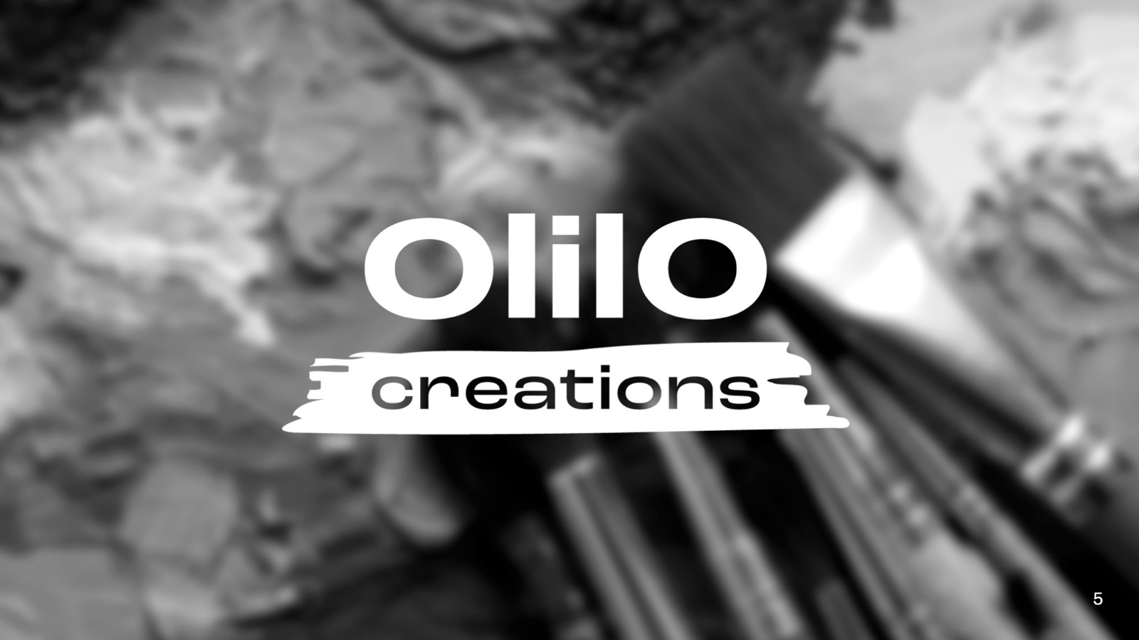 First logo proposition over a photo of paintbrushes